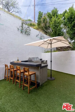 a view of a swimming pool with a table and chairs