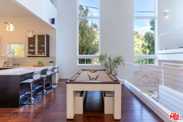 a kitchen with sink and wooden floor