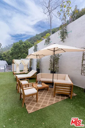 a view of a table and chairs in the grass