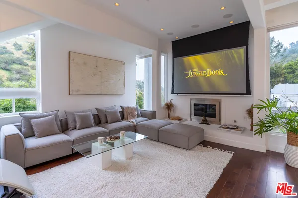 a living room with fireplace furniture and a flat screen tv