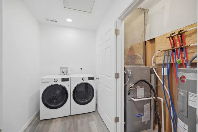 a view of a storage & utility room with dryer and washer