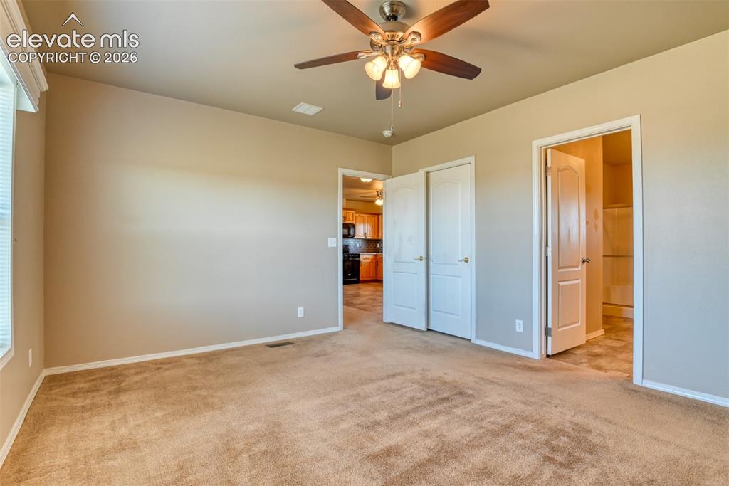 22558 Enoch Road Calhan, CO 80808 - Photo 13 of 50 an empty room with closet and a chandelier fan