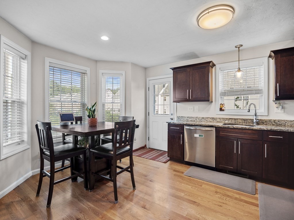 27 Riley Road, Unit 27 Tyngsborough, MA 01879 - Photo 11 of 37 a kitchen with granite countertop a sink dining table and chairs