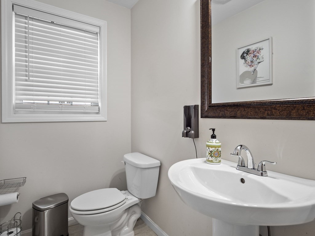 27 Riley Road, Unit 27 Tyngsborough, MA 01879 - Photo 15 of 37 a white toilet sitting next to a bathroom sink