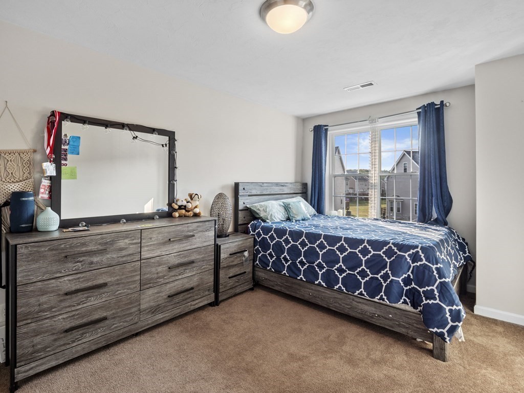 27 Riley Road, Unit 27 Tyngsborough, MA 01879 - Photo 16 of 37 a bedroom with a bed and window