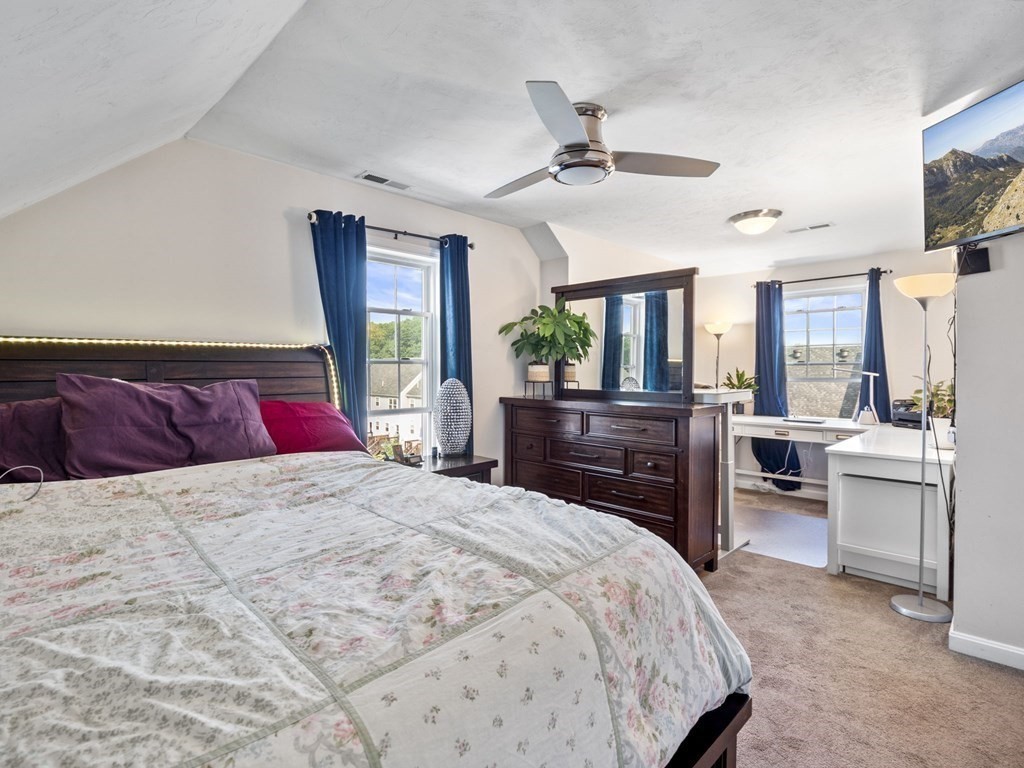 27 Riley Road, Unit 27 Tyngsborough, MA 01879 - Photo 26 of 37 a bedroom with a large bed and furniture