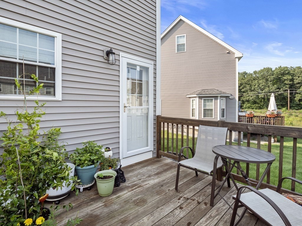 27 Riley Road, Unit 27 Tyngsborough, MA 01879 - Photo 30 of 37 a view of a house with patio and a yard