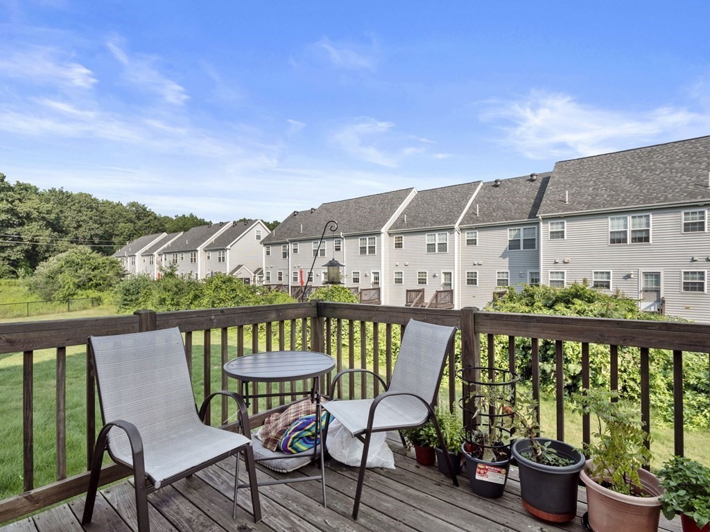 27 Riley Road, Unit 27 Tyngsborough, MA 01879 - Photo 31 of 37 a view of a balcony with two chairs and a table