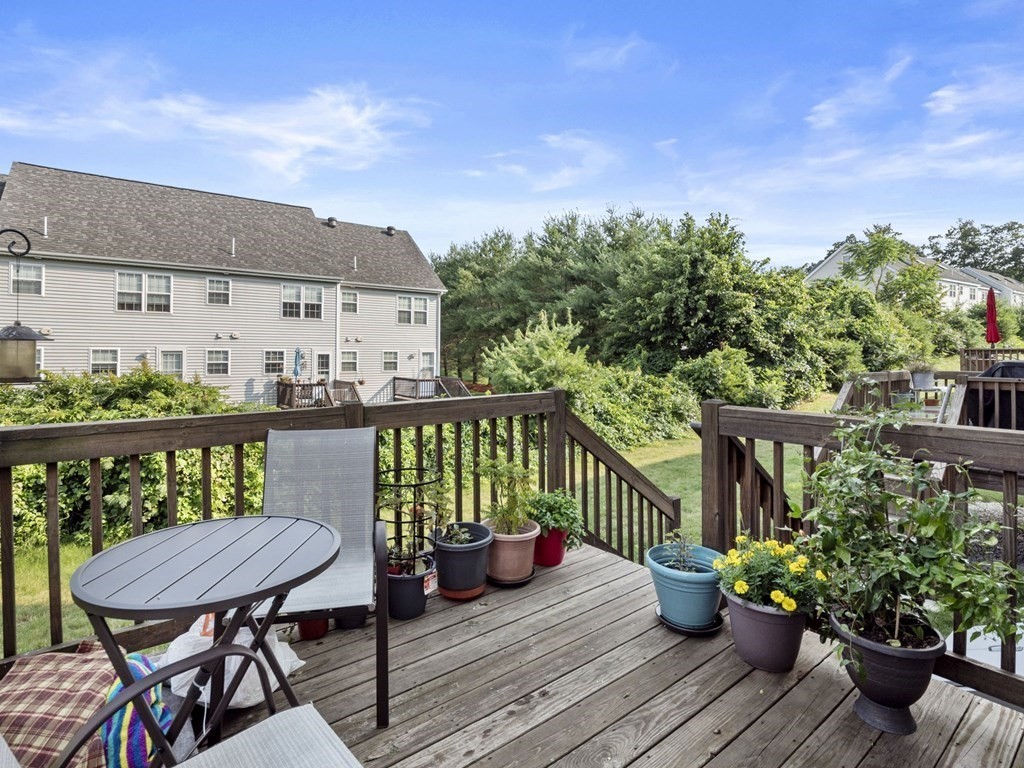 27 Riley Road, Unit 27 Tyngsborough, MA 01879 - Photo 32 of 37 a view of a chairs and table on the wooden floor