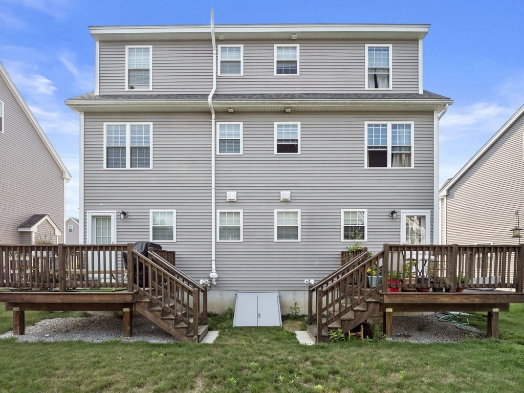 27 Riley Road, Unit 27 Tyngsborough, MA 01879 - Photo 35 of 37 a view of a house with a deck and a yard