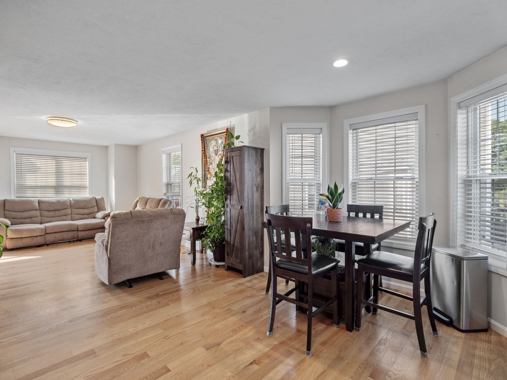 27 Riley Road, Unit 27 Tyngsborough, MA 01879 - Photo 9 of 37 a view of a dining room with furniture and wooden floor