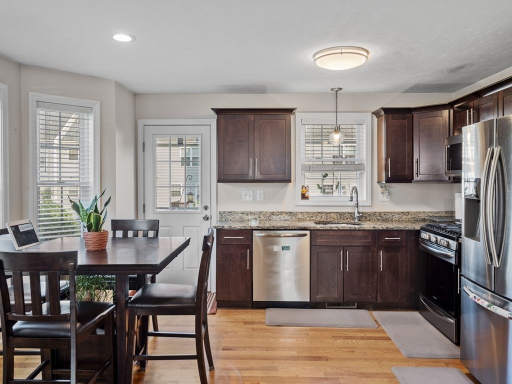 27 Riley Road, Unit 27 Tyngsborough, MA 01879 - Photo 10 of 37 a kitchen with granite countertop a sink stove and refrigerator