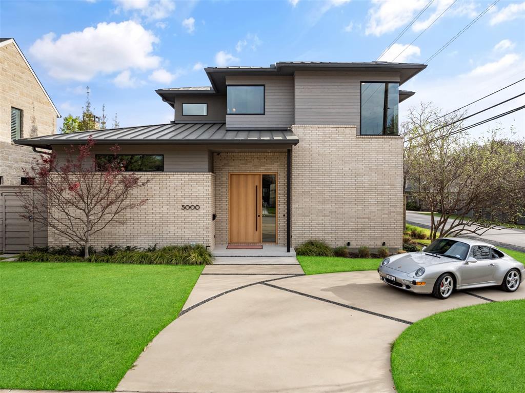 a front view of a house with a garden and plants