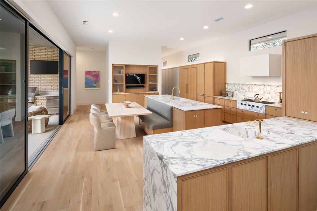 5000 Hanover Avenue Dallas, TX 75209 - Photo 11 of 36 a living room with stainless steel appliances kitchen island granite countertop a table chairs and a refrigerator