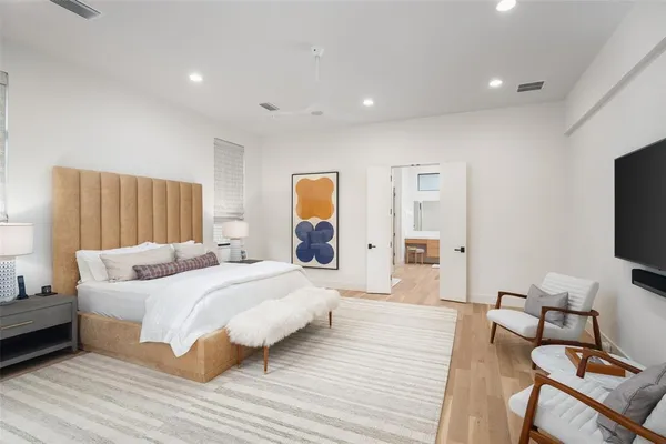 a bedroom with a bed and a flat screen tv