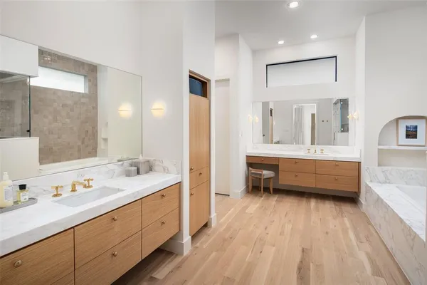 a bathroom with a double vanity sink and a mirror