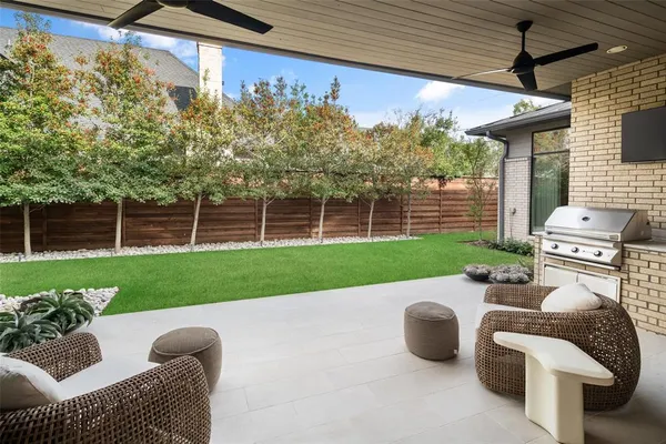 a view of a porch with furniture and a yard