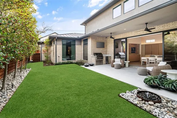 a view of a house with furniture and garden