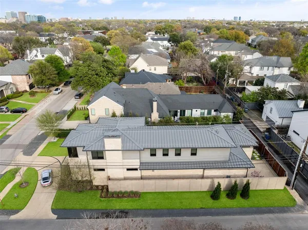 an aerial view of a house with a yard