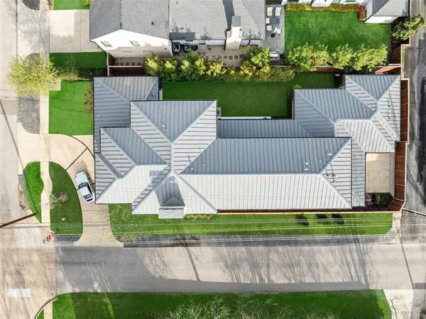 a front view of a house with a garden and plants