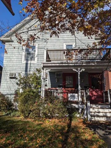 a front view of a building with lots of green space