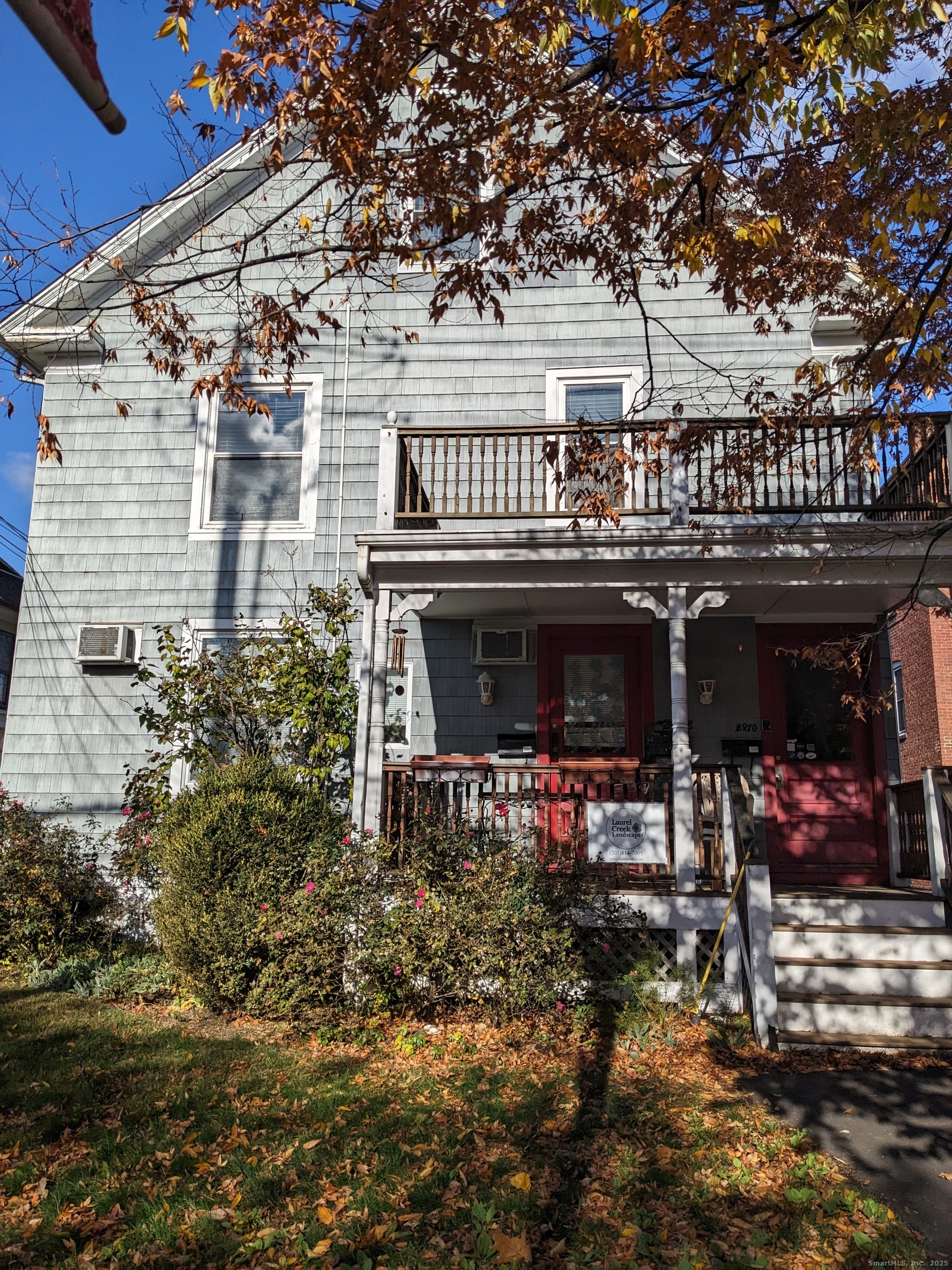 a front view of a building with lots of green space