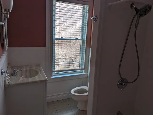 a bathroom with a sink toilet and shower