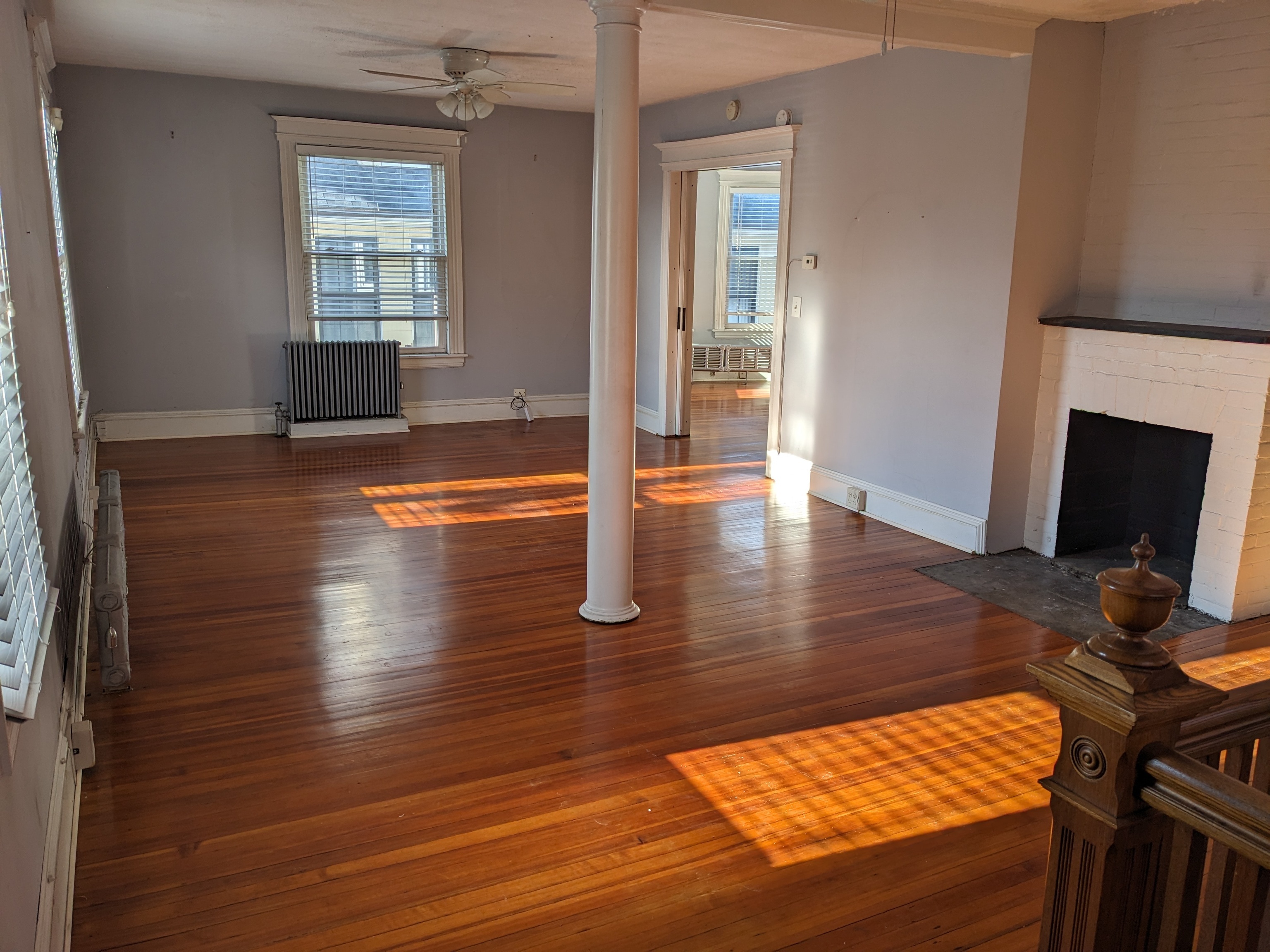2870 Fairfield Avenue, Unit 2 Bridgeport, CT 06605 - Photo 3 of 15 an empty room with wooden floor fireplace and windows