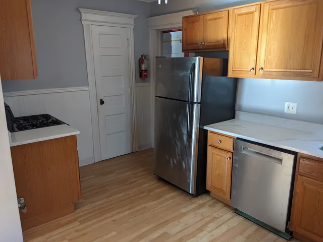 a kitchen with a refrigerator sink and stove