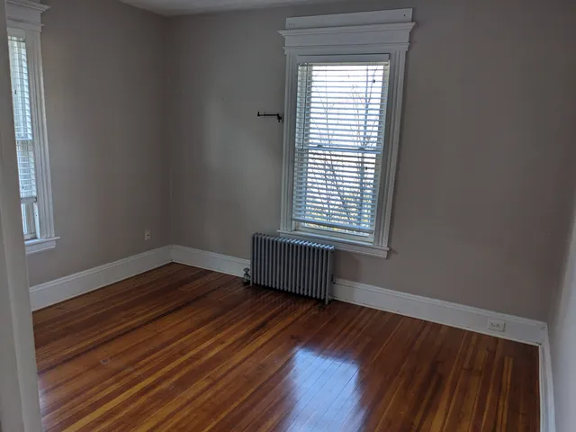 a room with a window and wooden floor