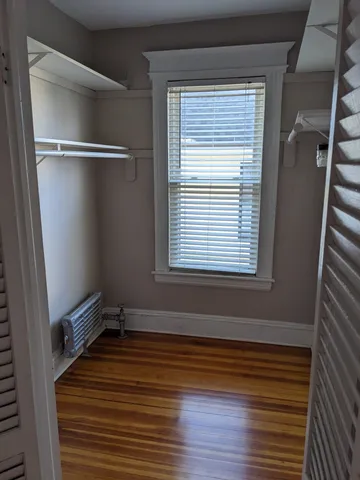 a view of a room with wooden floor and windows