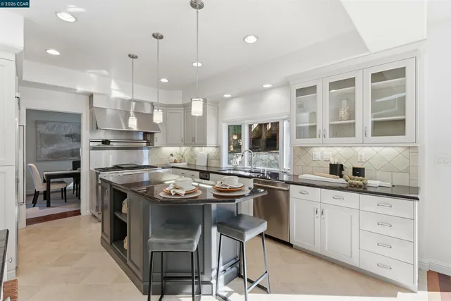 a kitchen with stainless steel appliances granite countertop stove a sink and a refrigerator