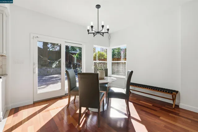 a view of a dining room with furniture window and wooden floor