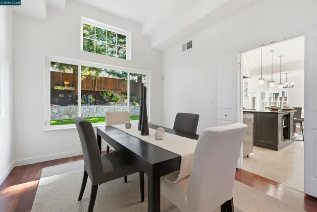 a view of a dining room with furniture and a window