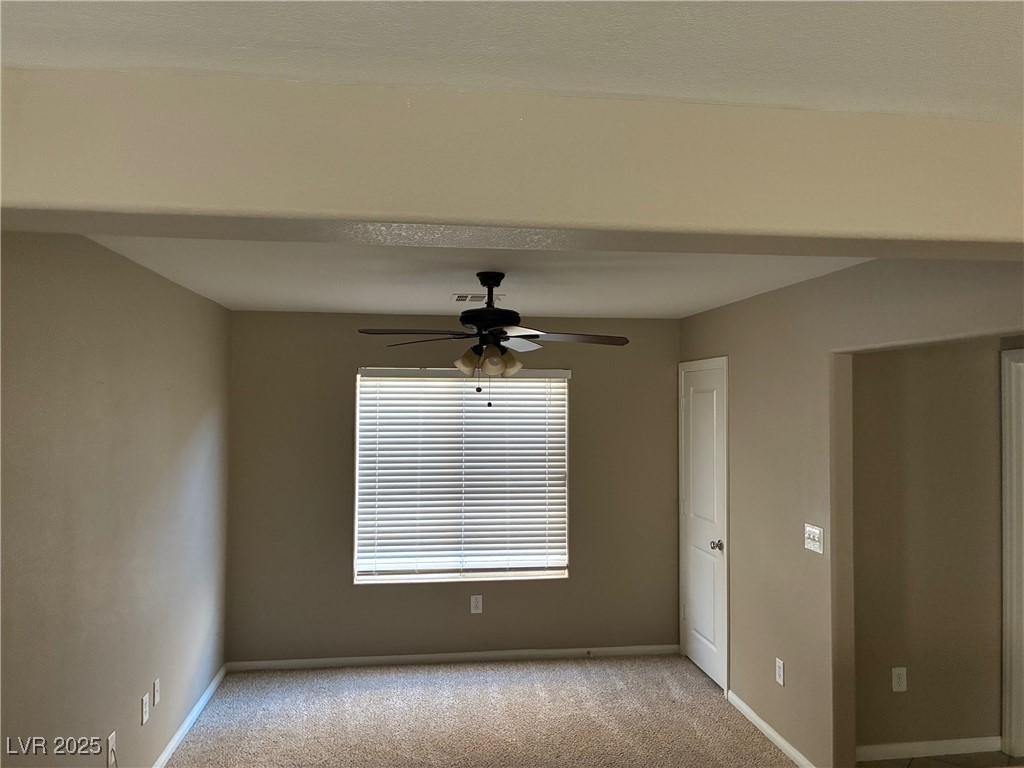 58 Lions Den Avenue North Las Vegas, NV 89031 - Photo 3 of 10 Carpeted empty room featuring baseboards