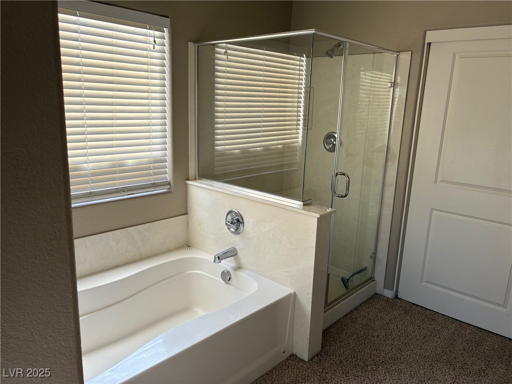 58 Lions Den Avenue North Las Vegas, NV 89031 - Photo 7 of 10 Bathroom with a garden tub and a stall shower