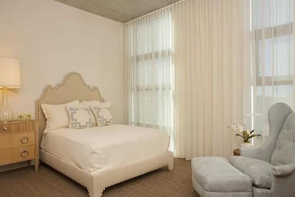 a bedroom with a bed and a couch