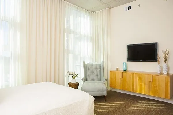 a bedroom with a bed and a television
