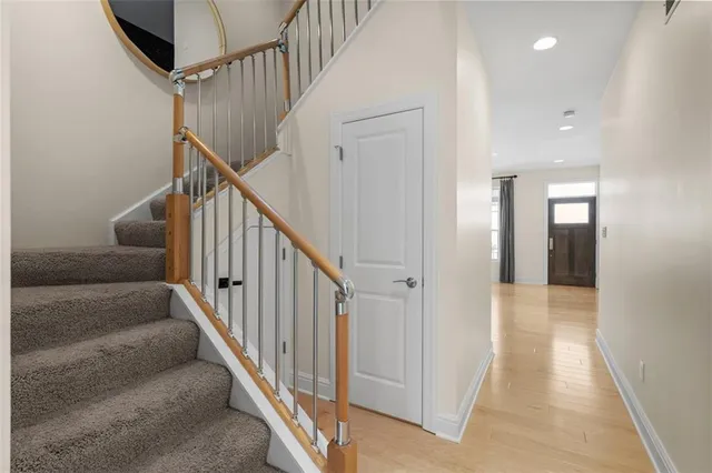 a view of a hallway with wooden floor and entryway