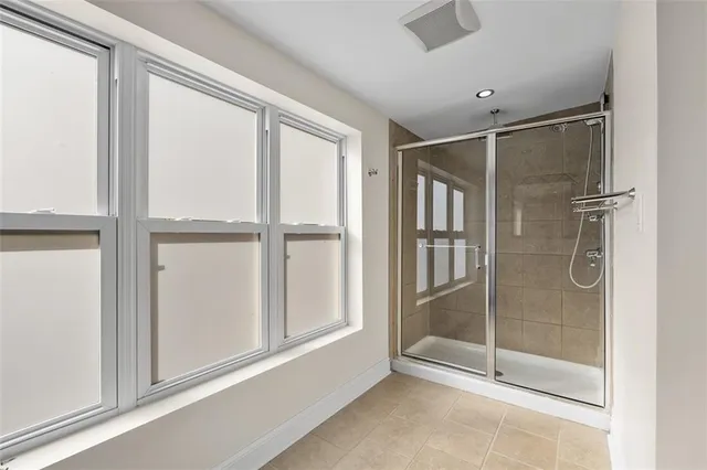 a bathroom with a glass shower door
