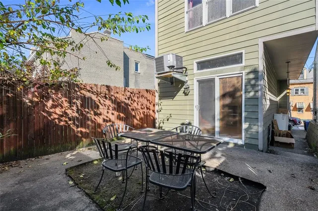 a view of a patio with table and chairs and potted plants