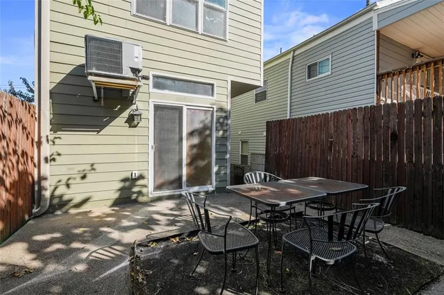 a backyard of a house with table and chairs