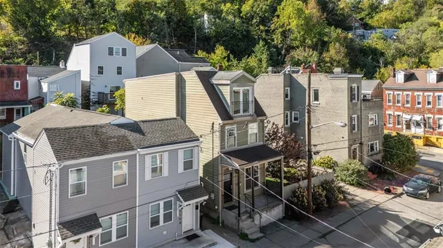 an aerial view of a house with a yard