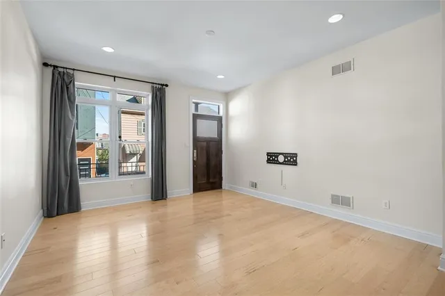 a view of an empty room with glass door