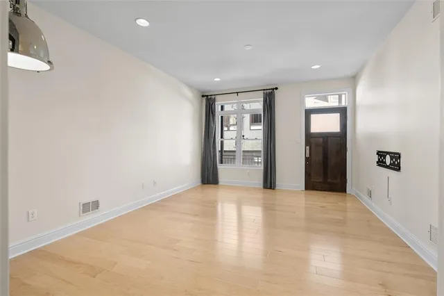 an empty room with windows and closet