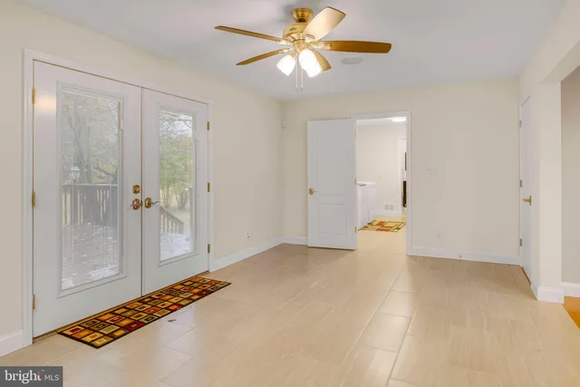 a view of empty room with a fan