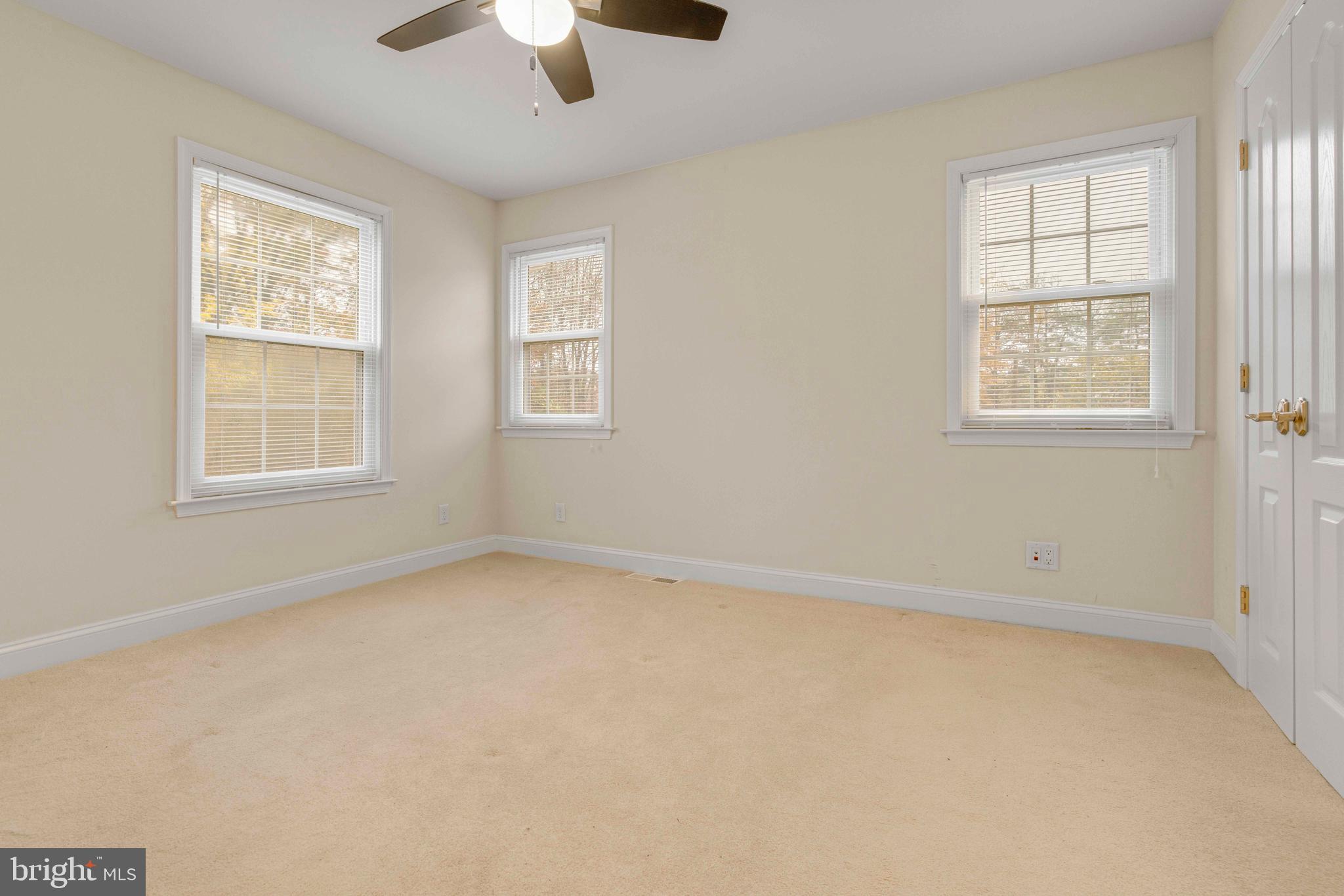 1608 County Line Road Chalfont, PA 18914 - Photo 18 of 31 an empty room with windows and chandelier fan