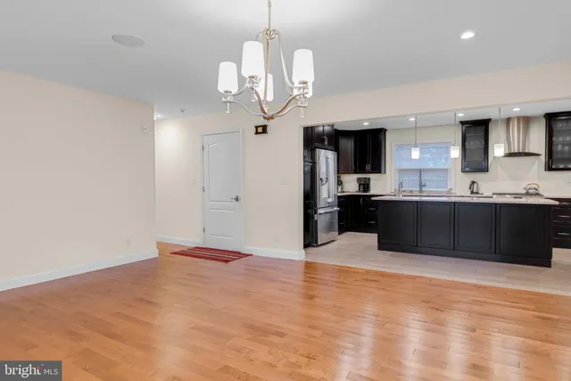 a view of kitchen and kitchen with granite countertop stainless steel appliances