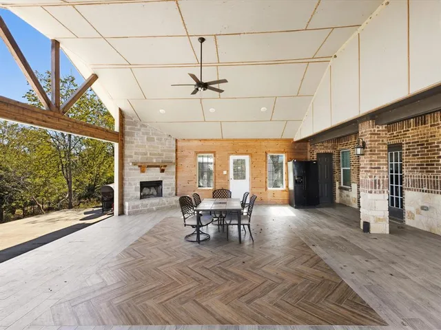 a view of a patio with table and chairs and potted plants