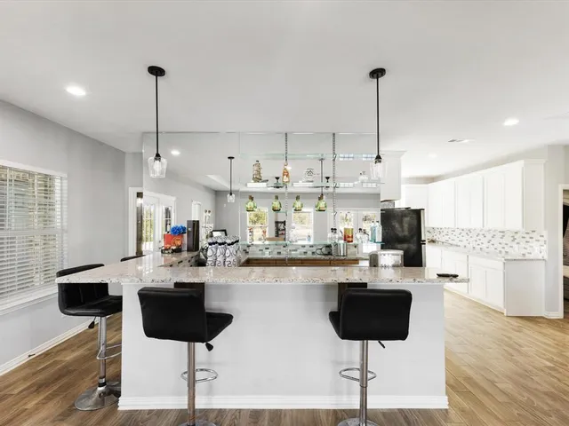 a kitchen with stainless steel appliances kitchen island granite countertop a sink and cabinets